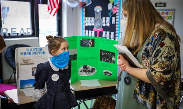 Student shares project with teacher